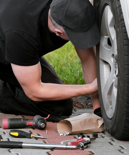 Driver Repairs Car